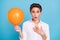 Photo of impressed blond young lady hold big balloon wear shirt isolated on blue color background