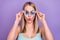Photo of impressed blond young lady touch spectacles wear blue top eyewear isolated on violet color background