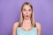 Photo of impressed blond young lady wear teal top isolated on violet color background