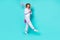 Photo of impressed carefree lady nightwear catching insects walking isolated teal color background