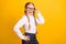 Photo of impressed cheerful pupil hand on waist touch glasses look camera  on yellow color background