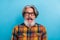 Photo of impressed funny retired man wear plaid shirt spectacles open mouth isolated blue color background