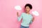 Photo of impressed wavy hairstyle millenial lady hold clouds look promo wear striped shirt isolated on pink color