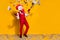 Photo of incognito wacky guy hold usd dropper gun wear cock mask red suit isolated yellow color background