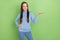 Photo of inspired smart lady hold empty space pick best option wear blue turtleneck isolated green color background