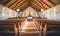 Photo of the interior of a church with neatly arranged rows of pews