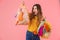 Photo of irritated caucasian woman showing bags with plastic waste