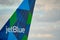 Photo of a jetblue airplane tail with company logo