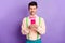 Photo of joyful attractive man hold look read smartphone message wear pink bowtie isolated on violet color background