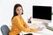 Photo of joyful brunette phone operator woman wearing microphone headset sitting in office and speaking with client