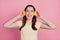 Photo of joyful glad carefree lady wear headphones listen music audio song on pink background
