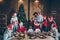 Photo of joyful mature small little people family merry x-mas gathering man in santa claus hat open sack bag give gift