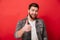 Photo of joyous bearded guy 30s in jeans jacket smiling and show