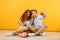 Photo of joyous boyfriend and girlfriend 20s sitting on floor to