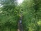 Photo of the landscape with trees on both sides of the dirty path and puddles, ideas for creating a calendar.