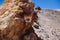 Photo of a large stone, hardened lava in the mountains, in the desert, sunny day, blue sky, texture 2