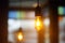 Photo of lights in cafe, restaurant or hotel. Fashion decoration with LED bulbs for party. Electric lamps indoors. Energy saving,