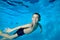 Photo of a little boy in class underwater at the bottom of a children`s pool. Active happy child. Healthy lifestyle