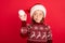 Photo of little girl curious interested hold fluffy ball wear santa hat eve time winter isolated over red color