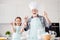 Photo of little girl granddaughter aged funny grandpa baking cookies together prepared ingredients hold eggs make dough