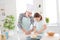 Photo of little girl granddaughter help aged grandpa mixing dough forming shape baking cake cookies together old chef