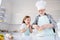 Photo of little girl granddaughter watching how aged grandpa breaking eggs make dough best friends baking cake cookies