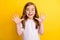 Photo of little impressed blond girl arms up wear spectacles white t-shirt  on yellow color background