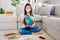 Photo of little pupil school lady hold big world globe homework task geography search foreign countries sit floor