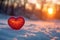 Photo Love in winter red heart displayed in snowy sunset