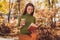 Photo of lovely charming lady come autumn park relax drink coffee read fiction novel fantasize herself princess other