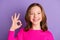 Photo of lovely cheerful young teenager girl make okay sign smile good mood isolated on violet color background