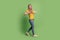 Photo of lovely dream blonde lady show like symbol with fingers walk wear casual outfit on green background