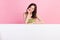 Photo of lovely dreamy lady arm touch face interested look placard poster empty space  on pink color background