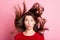 Photo of lovely girl funny look camera lips wind blow hair wear red sweater isolated pink color background