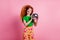 Photo of lovely stunning woman with fluttering ginger hair dressed green t-shirt hold retro discoball isolated on pink