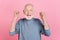 Photo of lucky excited guy pensioner dressed grey pullover smiling rising fists isolated pink color background