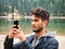 Photo of a man capturing the breathtaking beauty of the Dolomites from a boat in Italy