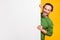 Photo of man hide behind white placard empty space look camera wear green sweater isolated yellow color background