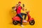 Photo of man ride scooter hold terminal credit card wear bag red t-shirt cap isolated yellow color background