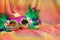 Photo of Mardi Gras and Purim mask over colorful chiffon background