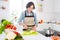 Photo of mature nice lady cut zucchini wear apron jeans shirt at kitchen alone