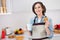 Photo of mature nice lady drink tea eat sweets wear apron jeans shirt at kitchen alone