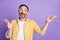 Photo of mature positive happy man look empty space speak raise hands isolated on purple color background
