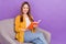 Photo of mature woman read book hobby cozy enjoy weekend sit chair isolated over purple color background