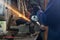 Photo of mechanic grinding a metal plate in workshop