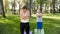 Photo of middle aged mother with her teenage boy child doing yoga and breathing exercises at park. Family taking care of