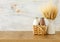 Photo of milk and chocolate next to wheat over wooden table and white background. Symbols of jewish holiday - Shavuot