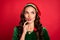 Photo of minded girlish lady look empty space pout lips wear elf costume hat isolated red color background