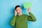 Photo of minded smart guy hold speech bubble look empty space wear green sweater isolated blue color background