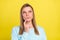 Photo of minded smart pensive girl finger chin look up empty space wear blue pullover isolated on yellow background